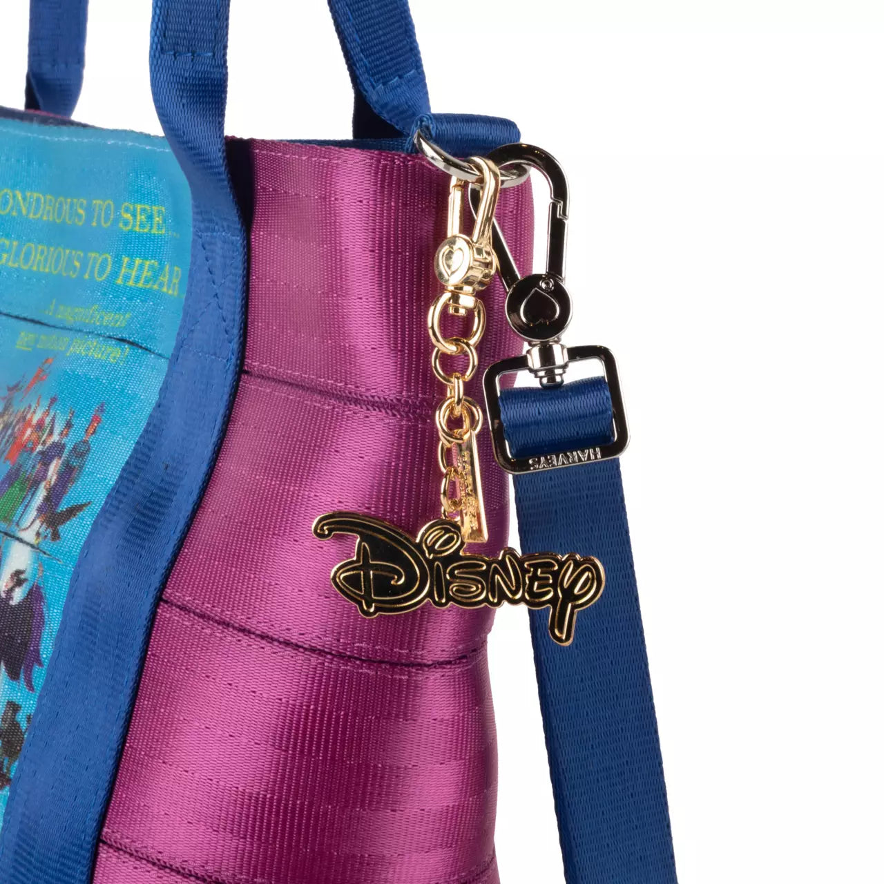 Purple bag with a blue strap featuring a Disney keychain on a white background