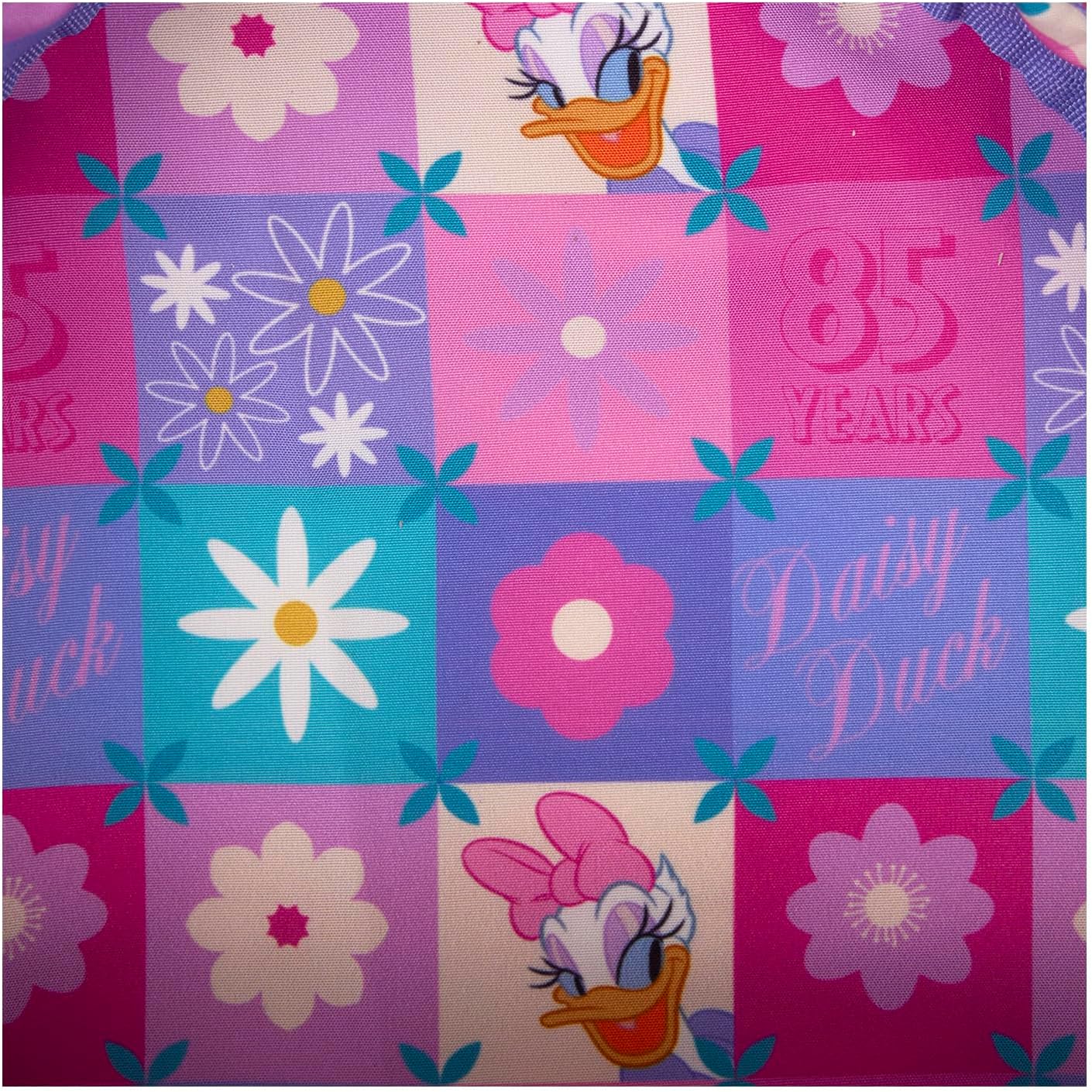 Fabric with Daisy Duck designs and floral patterns on a checkered background.