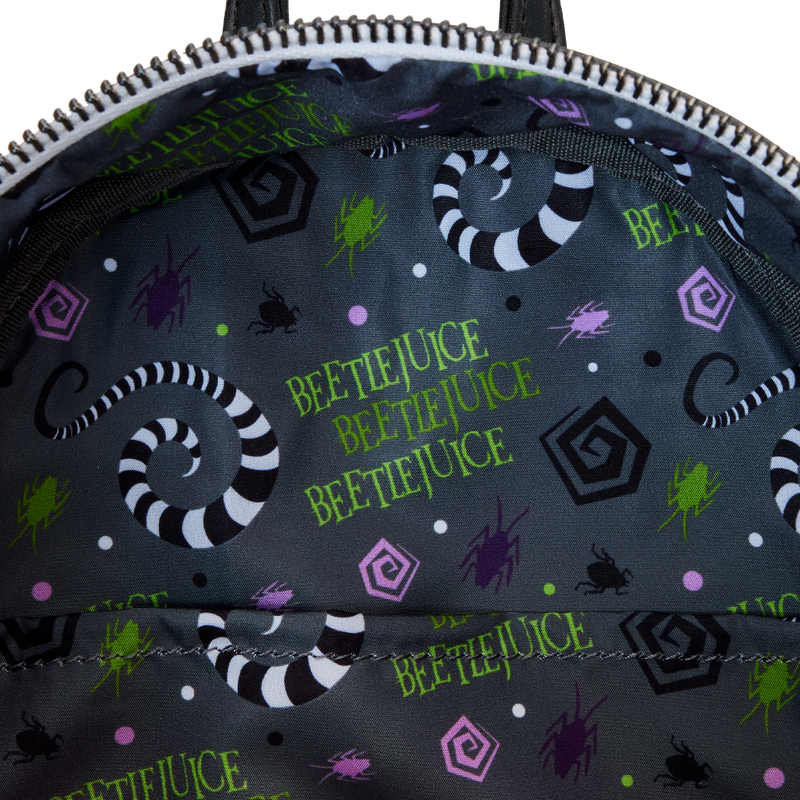 Inside of the Side view of the Beetlejuice Western Mini Backpack with Beetlejuice pattern featuring text and sandworm graphics on a dark background