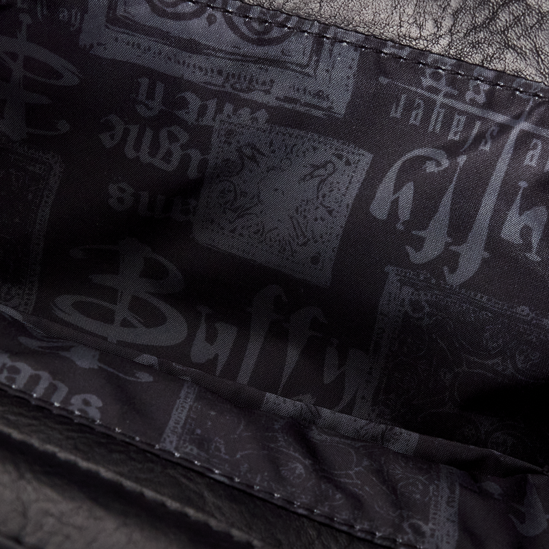 Close-up of the inside lining of the mini backpack with 'Buffy' branding on a dark background