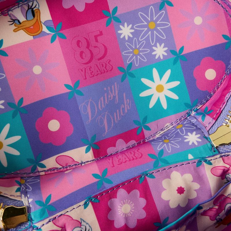 Colorful fabric with floral patterns and '85 Years Daisy Duck' text on a patchwork design.