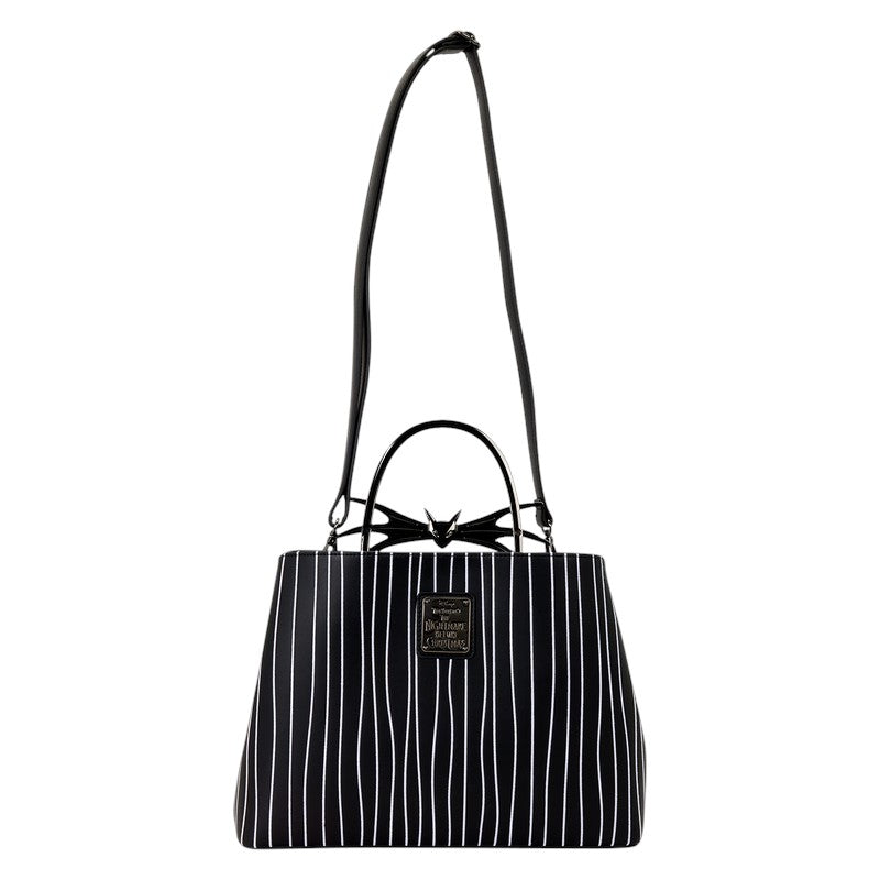 Black and white striped handbag with a Jack Skellington bow detail on a white background