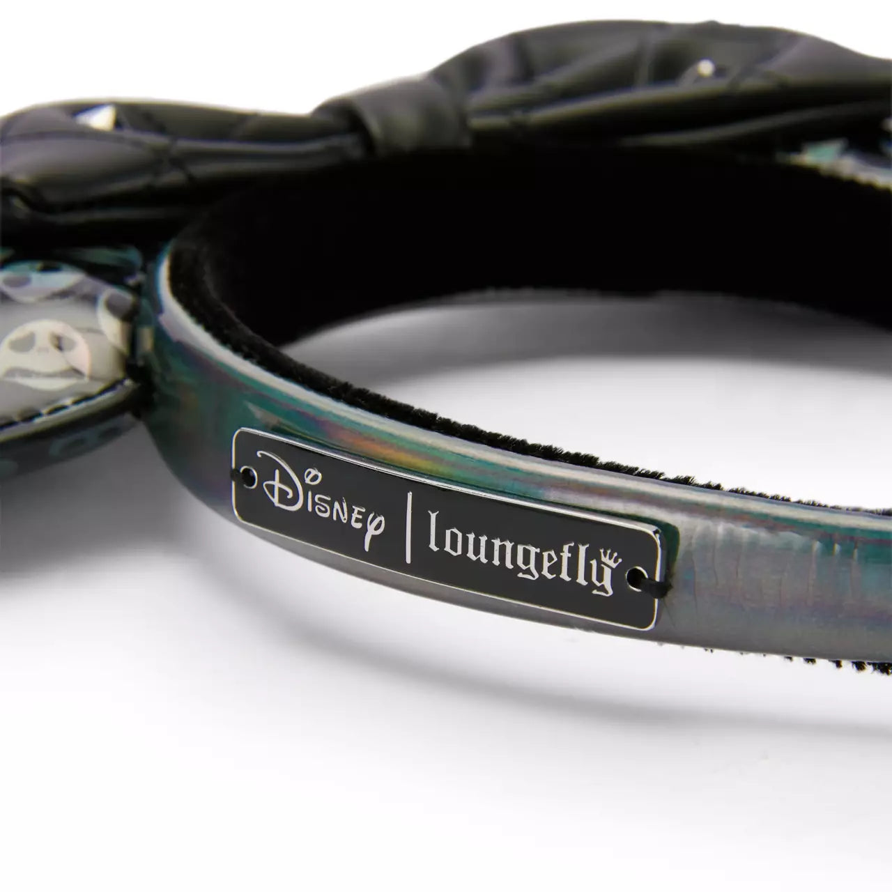 Close-up of a Disney Loungefly product with a label on a white background