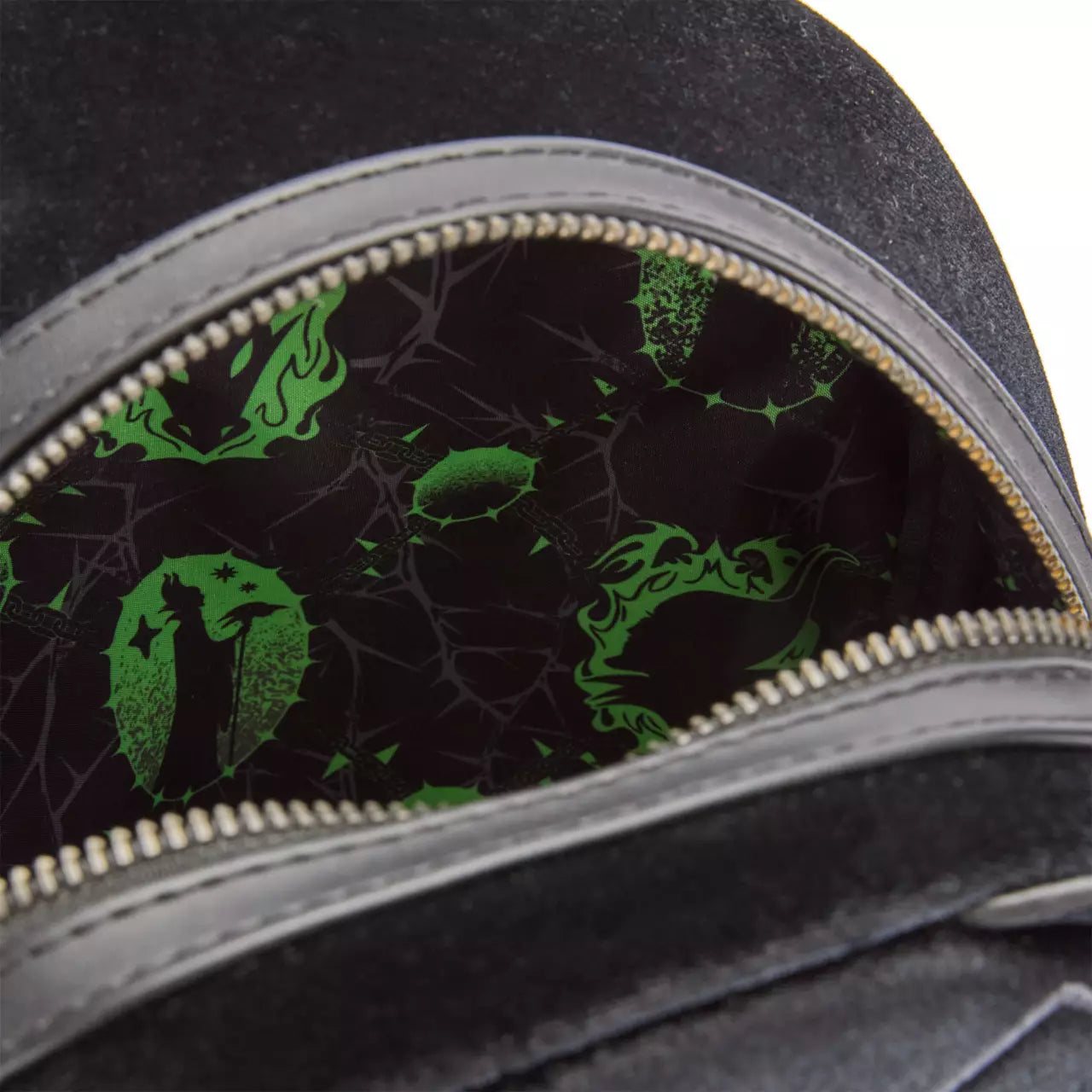 Close-up of a black bag with green designs on a dark background