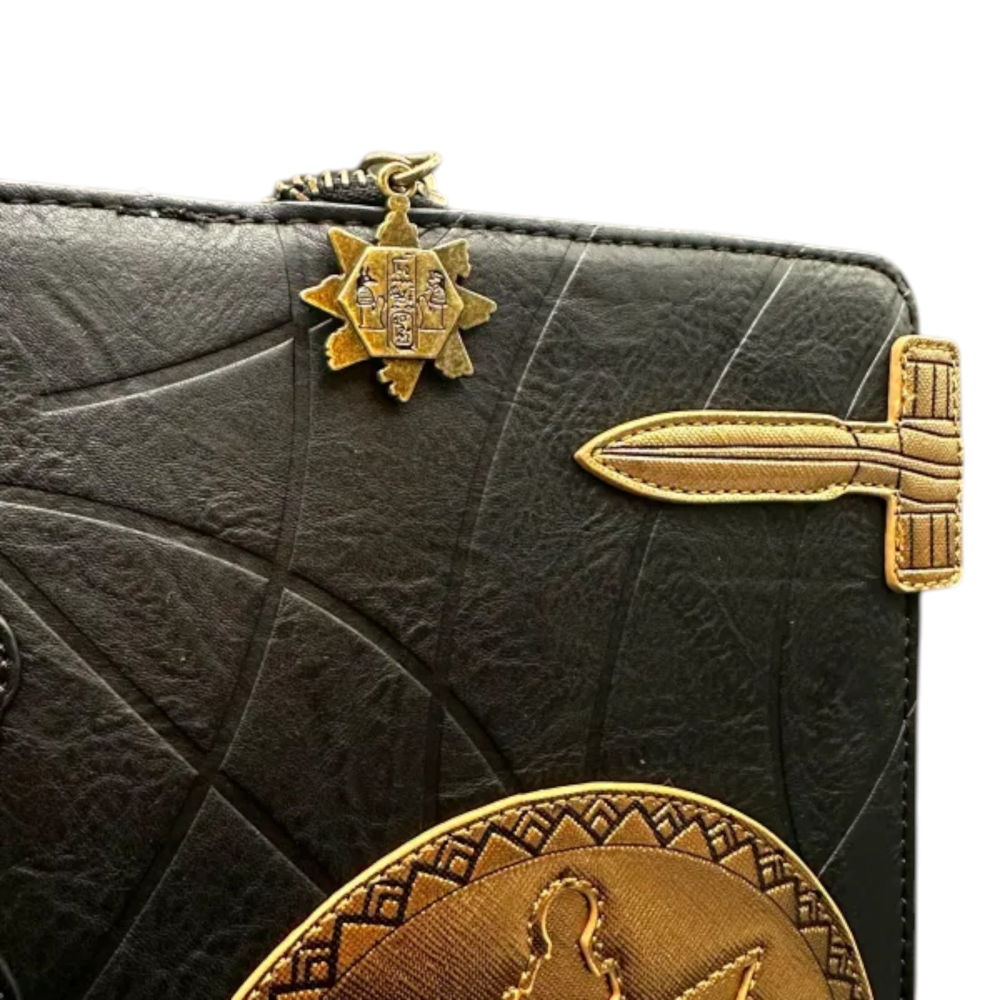 Black leather mini backpack with gold accents and embossed designs on a white background