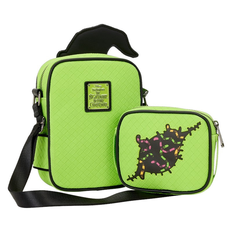 Green bag with black strap and character design on a white background