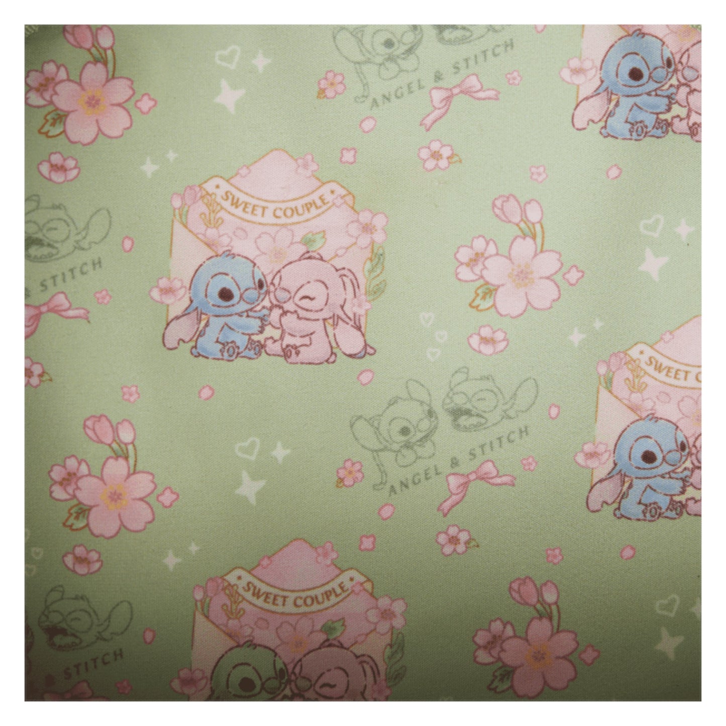 Inside Front Stitch & Angel Cherry Blossom Bow Handle Crossbody Bag with strap and floral design on a white background Patterned with stitch and angel characters and floral designs on a green background