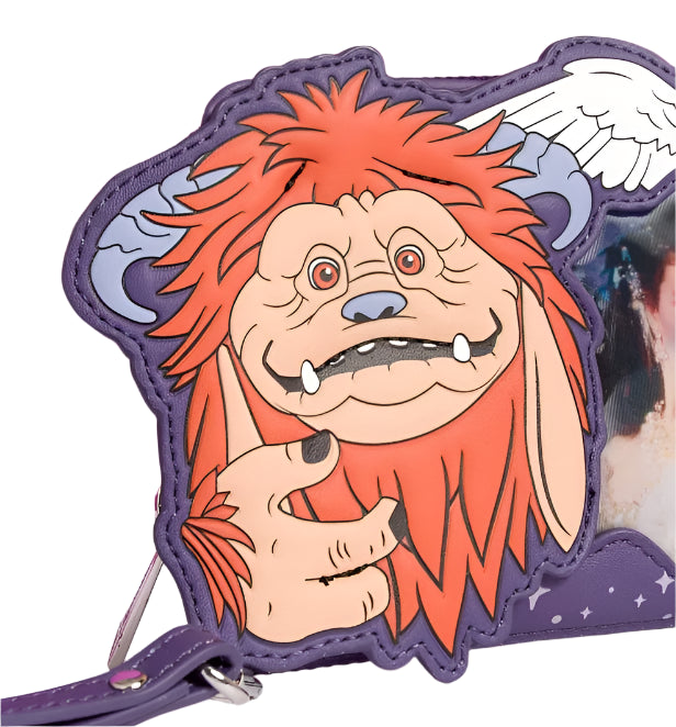 Ludo with reddish-orange hair and a purple background on wristlet