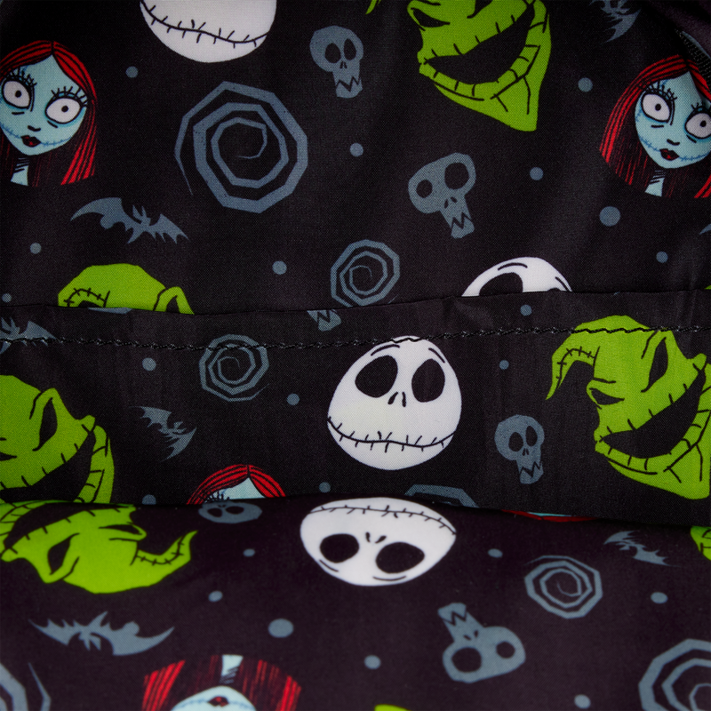 Patterned fabric with characters from 'The Nightmare Before Christmas' on a dark background
