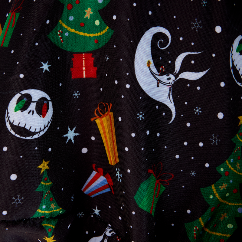 Inside NBC Christmas Town Carousel crossbody bag with Christmas-themed fabric with trees, presents, and a moon on a dark background