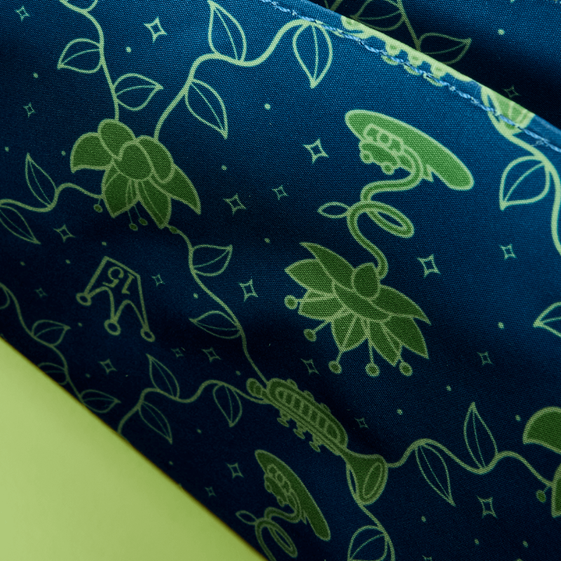 Close-up of green floral pattern on blue fabric