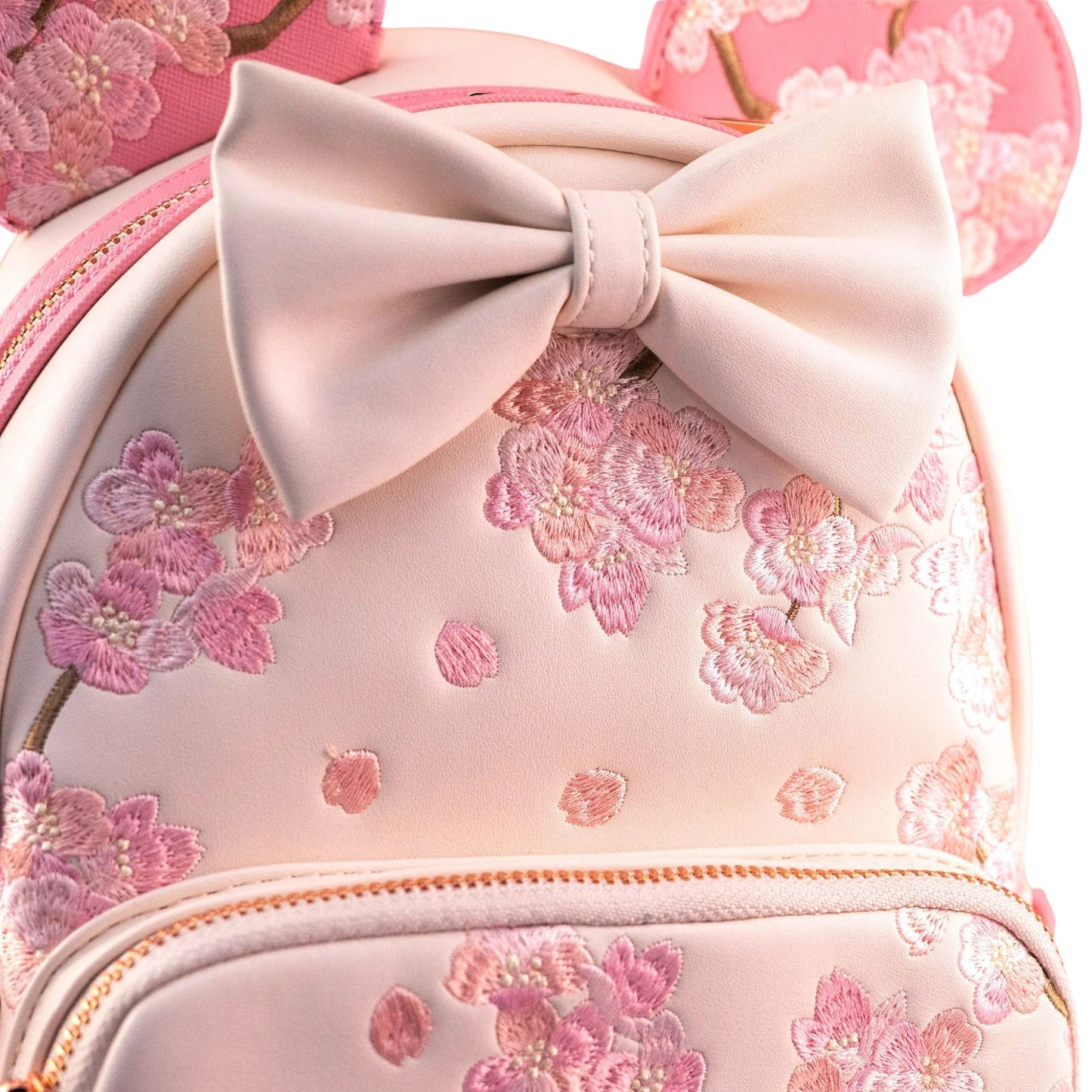 Pink backpack with floral embroidery and a large bow on a white background