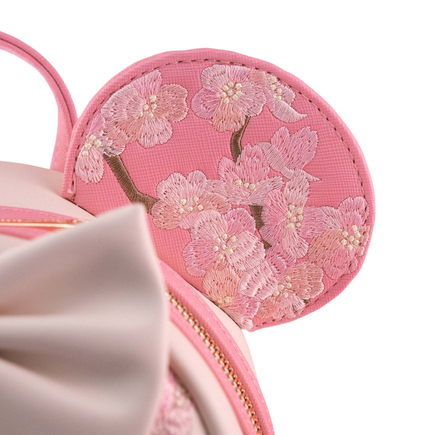 Pink Minnie Mouse ear with floral embroidery on a white background
