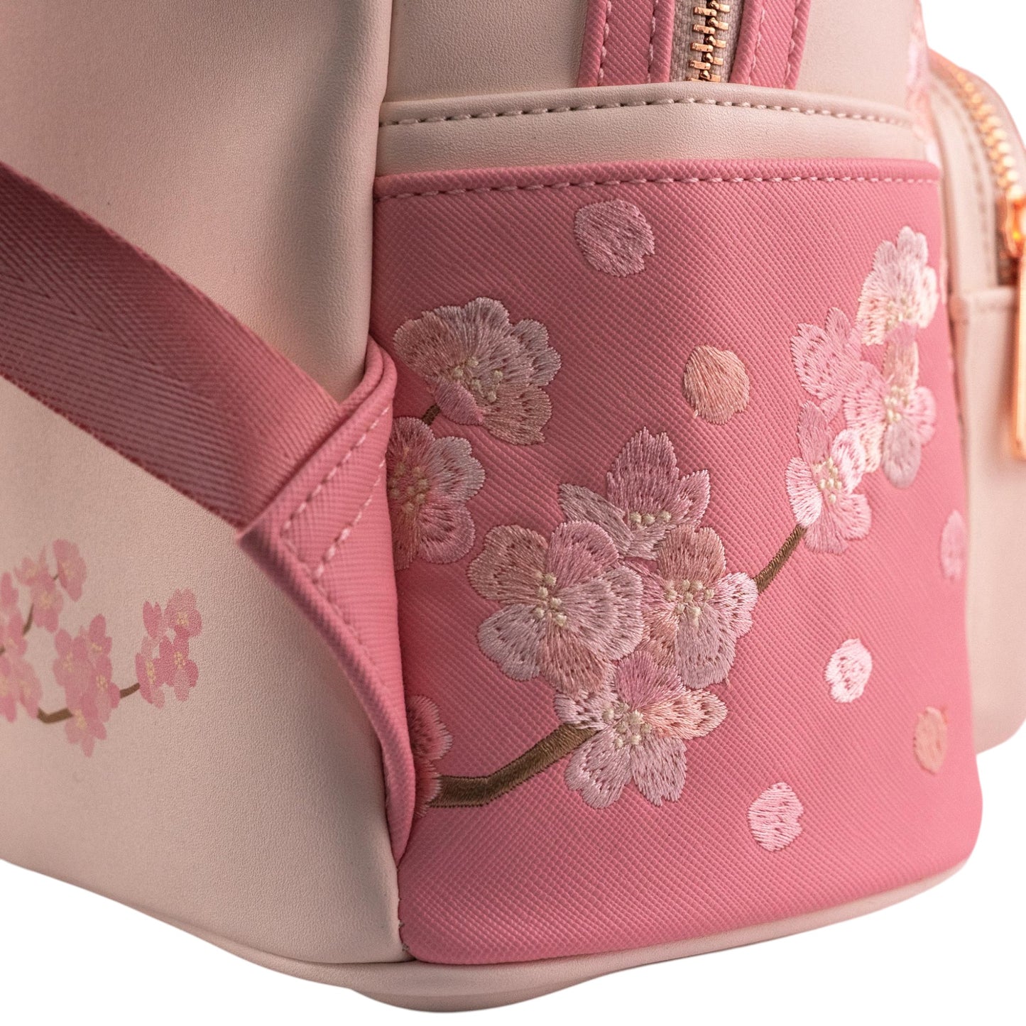 Pink backpack with cherry blossom embroidery on a white background