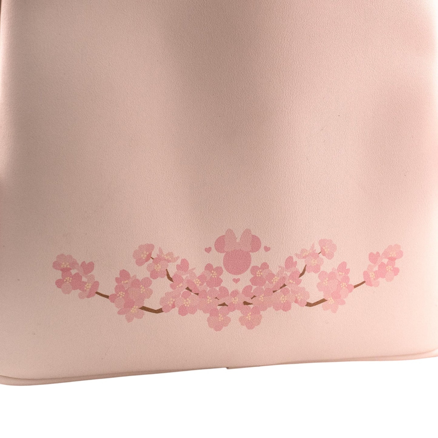 Pink Minnie Mouse backpack with cherry blossom design on a white background
