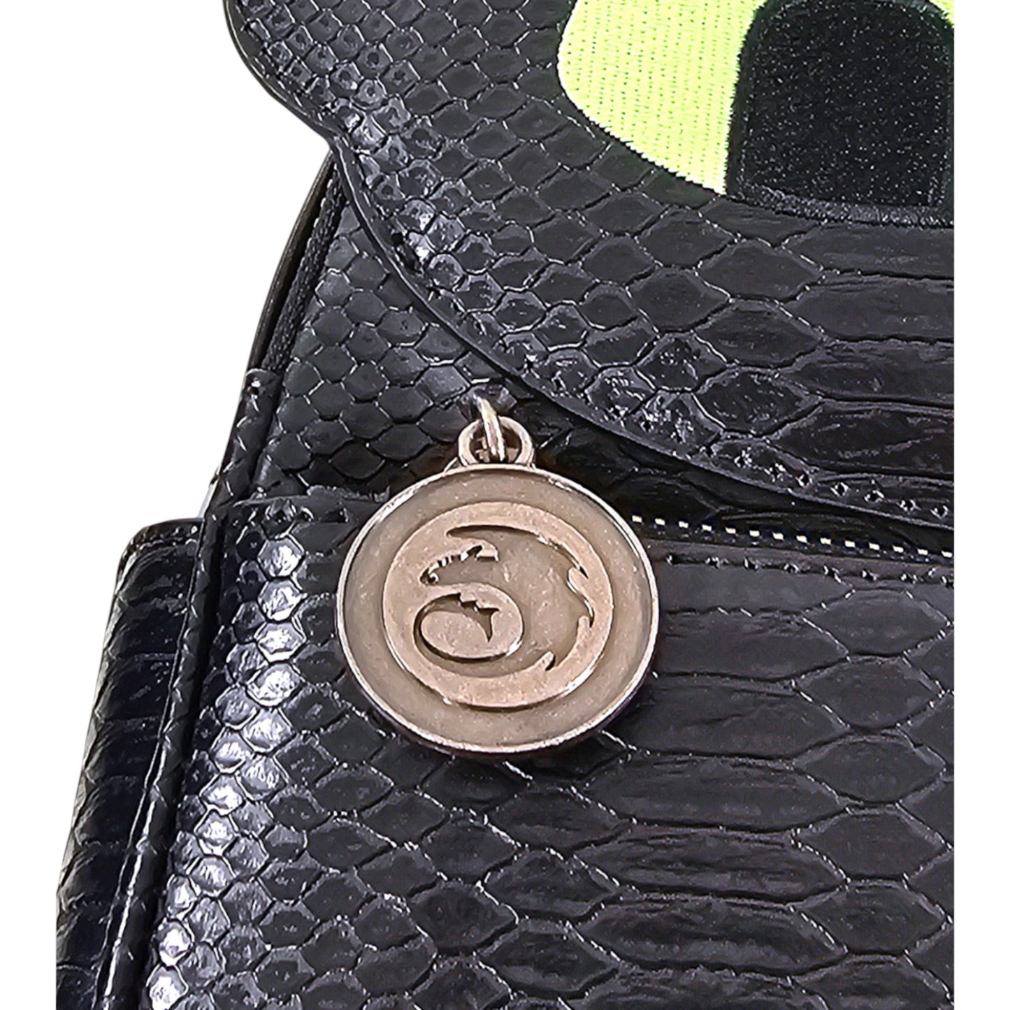 Black textured mini backpack with a circular metal emblem featuring a How to Train Your Dragon logo.