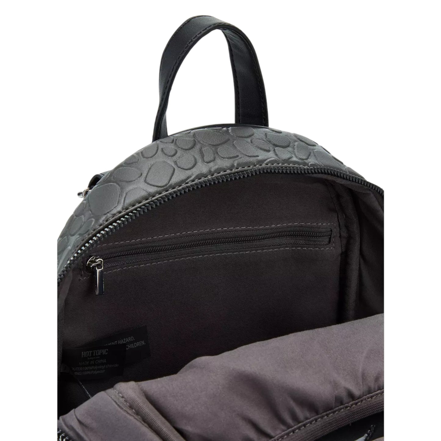 Close-up of a black backpack with textured top panel on a white background