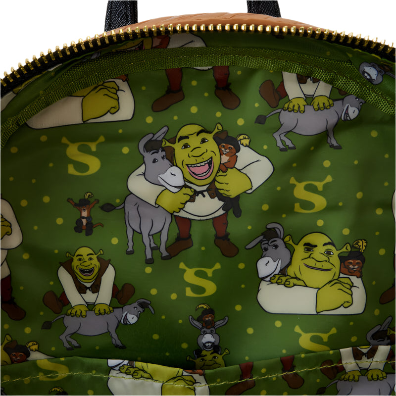 Close-up of a green bag with Shrek, Donkey, and Puss in Boots  illustrations on a green background.