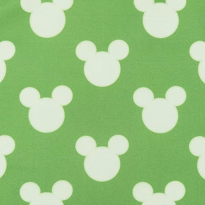 White Mickey Mouse ears pattern on a green background