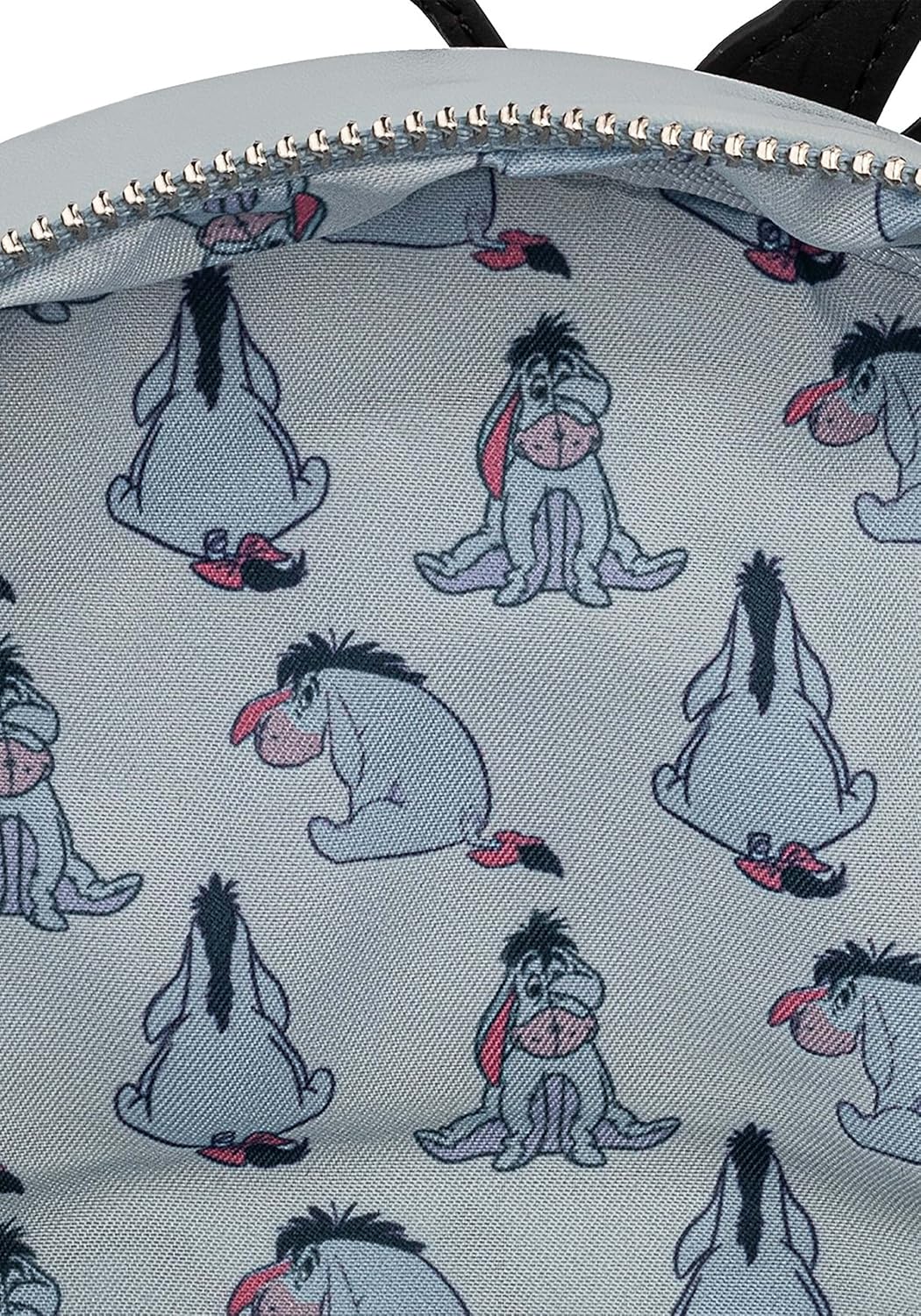 Backpack with Eeyore pattern on a light gray background