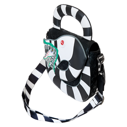 Side view of the black and white striped Beetlejuice Sandworm Crossbody Bag  with picture of the sandworm's face on a white background