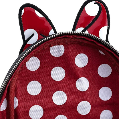 Red polka dot backpack with black accents on a white background