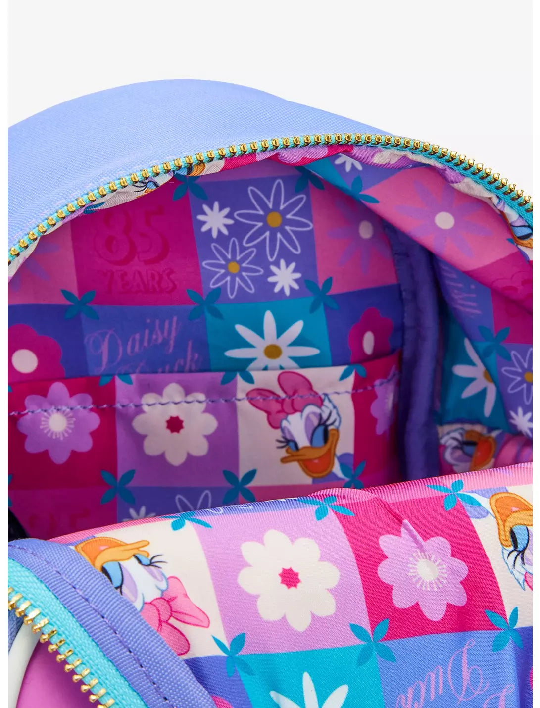Inside of backpack with Daisy Duck design and floral patterns