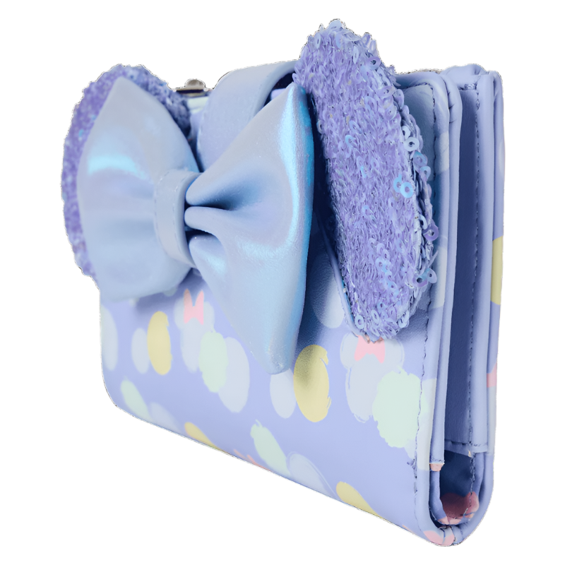 Light blue wallet with a large bow and colorful polka dot pattern on a white background