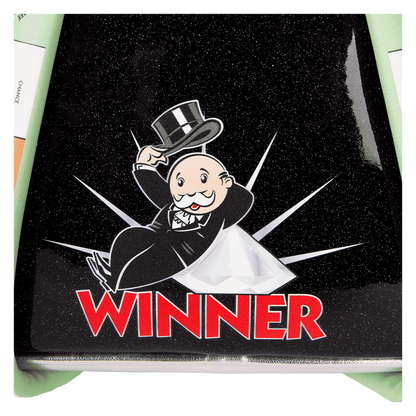 Back close-up view of the Side view of the Monopoly 90th Anniversary Pennybags Glitter Cosplay mini backpack with Monopoly character in a top hat and tuxedo on top of the text 'Winner'..