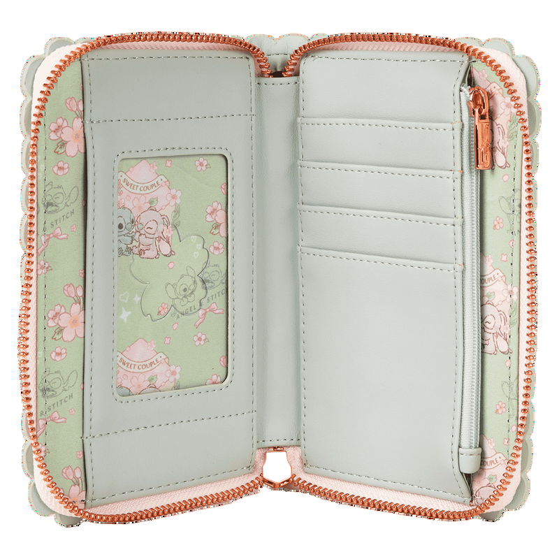 Light green wallet with floral design and rose gold zipper on a white background