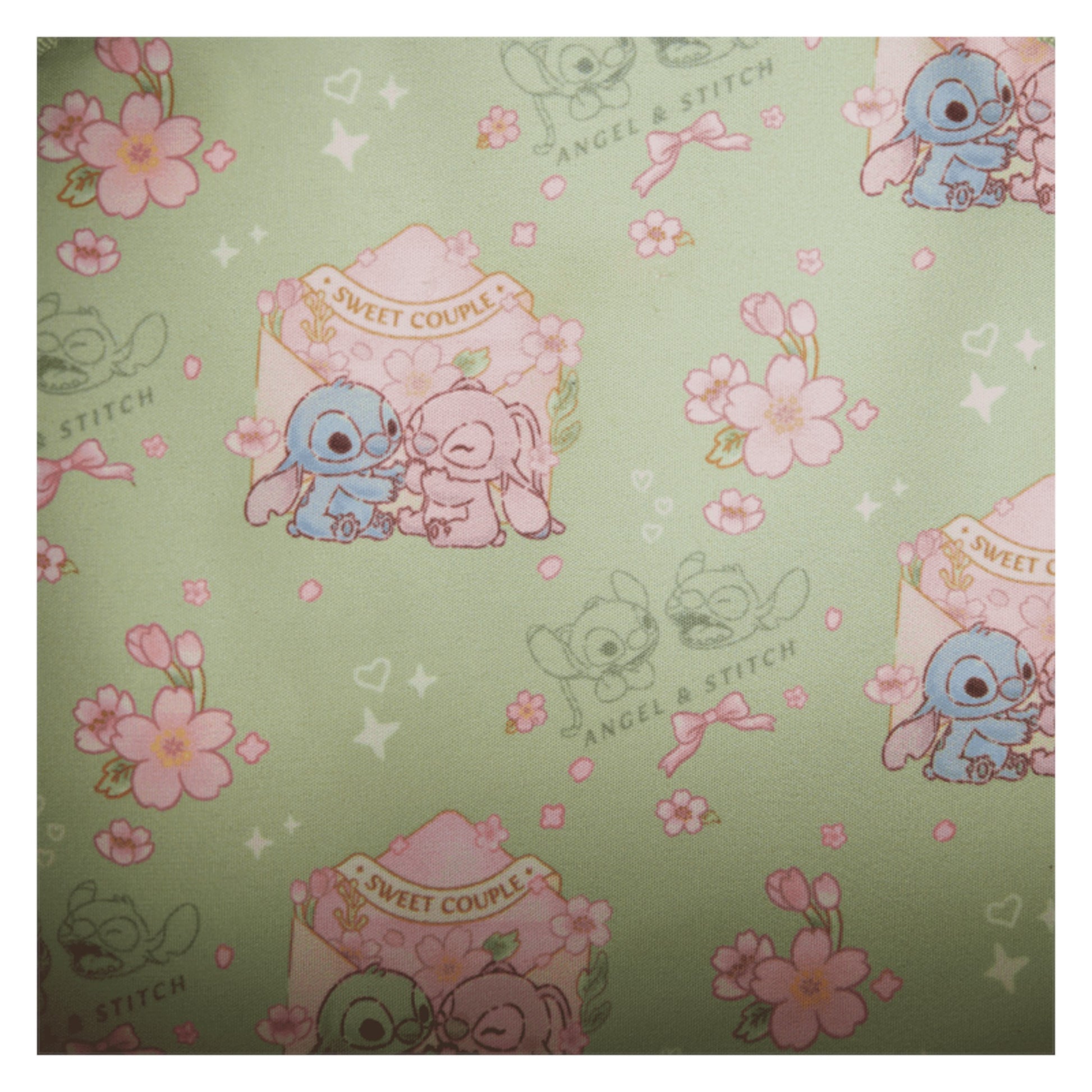 Inside Front Stitch & Angel Cherry Blossom Bow Handle Crossbody Bag with strap and floral design on a white background Patterned with stitch and angel characters and floral designs on a green background