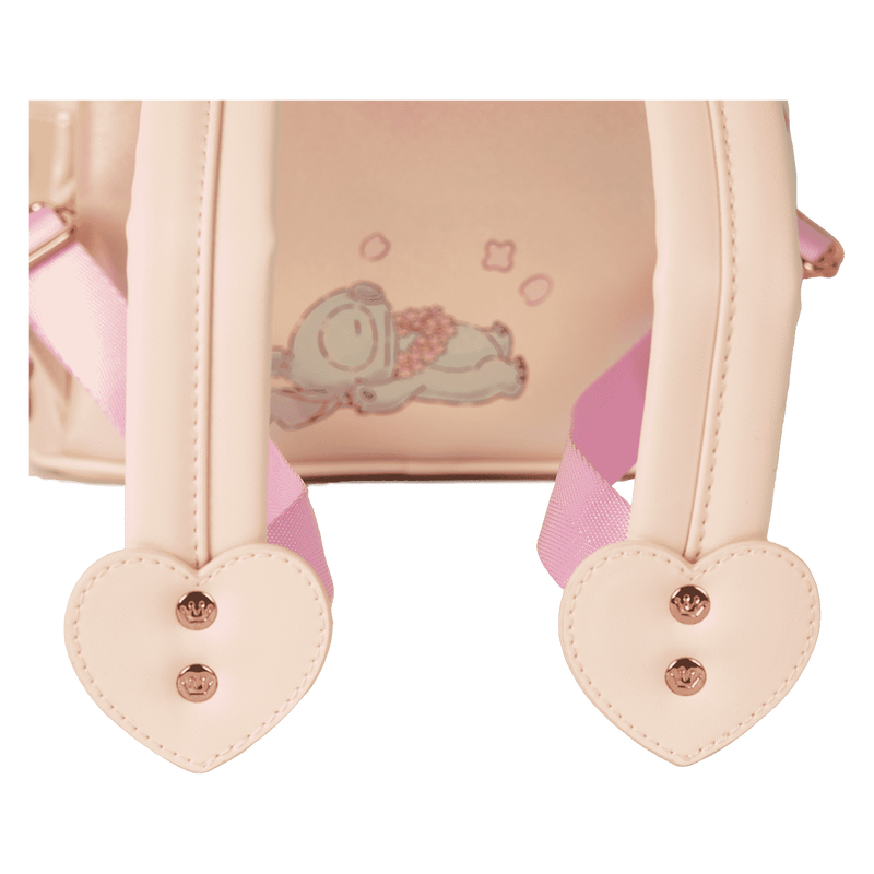 Heart-shaped straps with buttons on a pink backpack with cartoon design.
