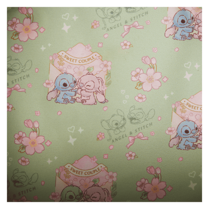 Patterned fabric with stitch and angel and floral designs on a green background