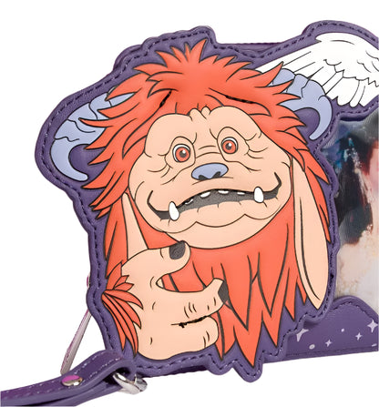 Ludo with reddish-orange hair and a purple background on wristlet