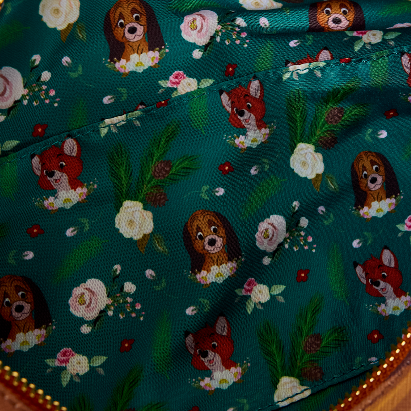 Inside view of The Fox and the Hound Forest Floral Log Figural Crossbody fabric with fox and hound pattern on a teal background