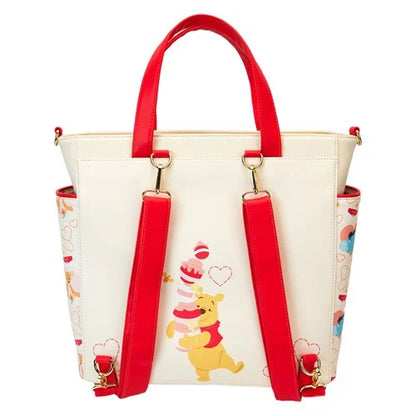 White handbag with red handles and strap featuring Winnie the Pooh on a white background