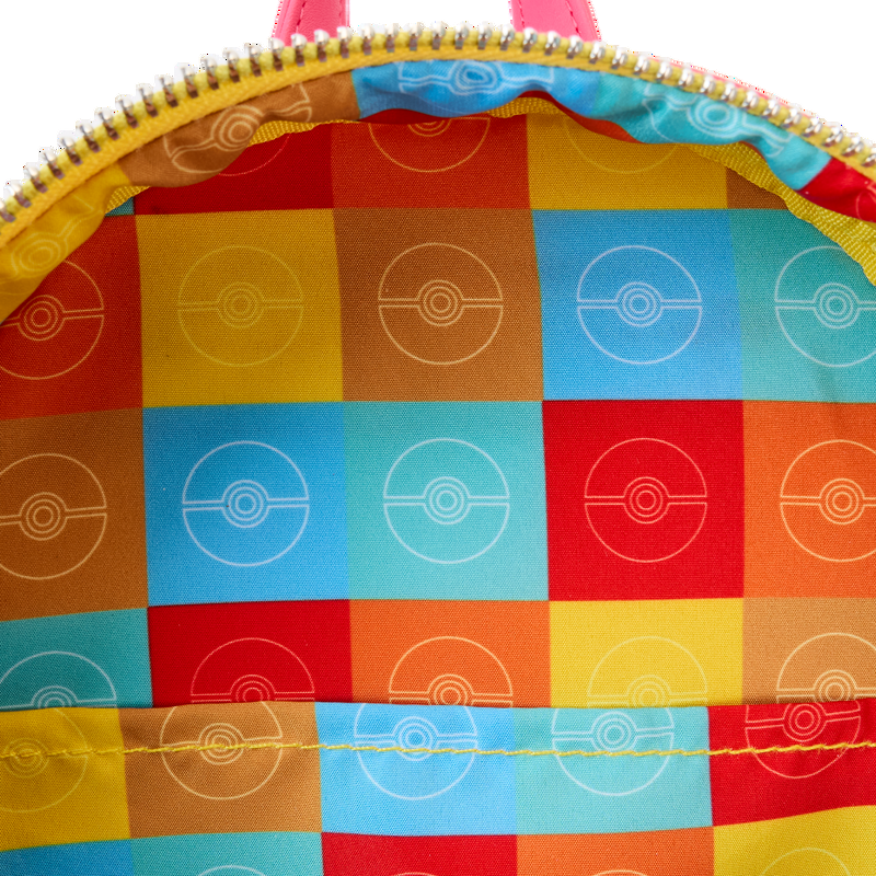 Inside Pokémon Santa Pikachu backpack Close-up of a colorful fabric with geometric pattern and yellow zipper on a white background
