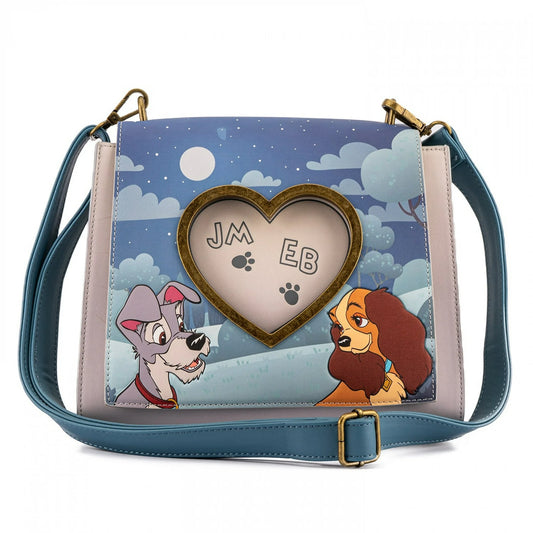 Handbag with Lady and the Tramp characters and a heart-shaped nameplate on a blue background