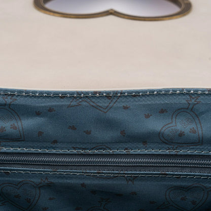Close-up of a blue fabric with heart patterns and stitching details.