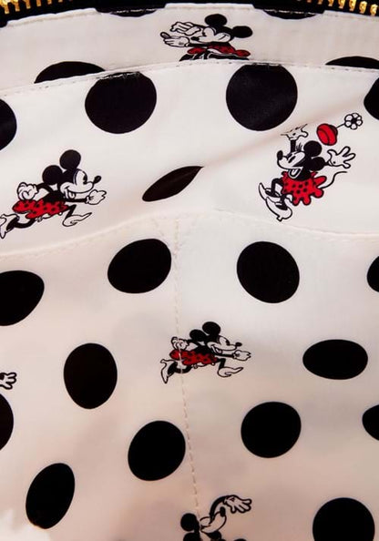Close-up of a polka dot fabric with Minnie Mouse designs on a white background