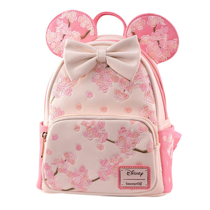 Pink Minnie Mouse backpack with cherry blossom design and bow, featuring a Disney logo.