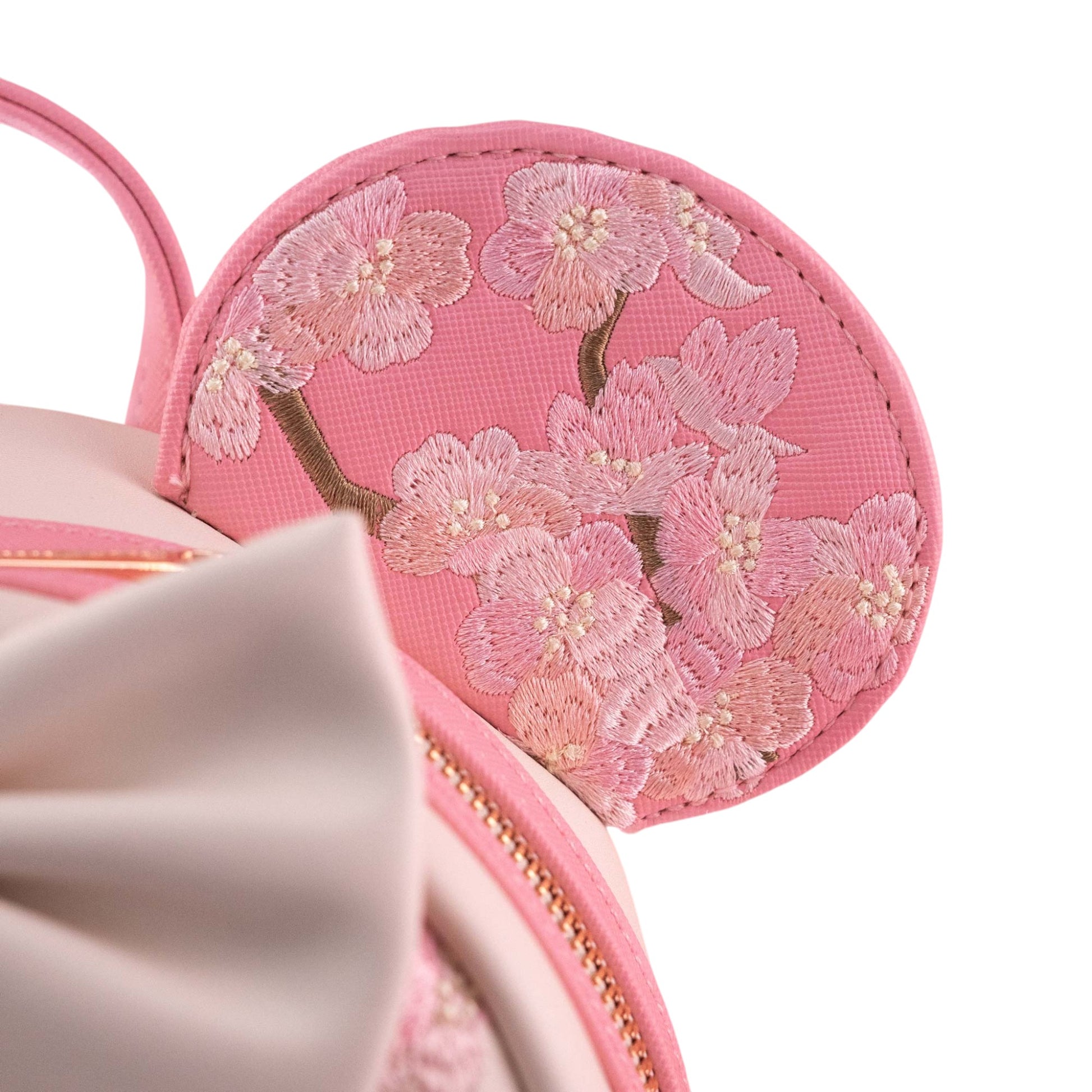 Pink Minnie Mouse ear with floral embroidery on a white background