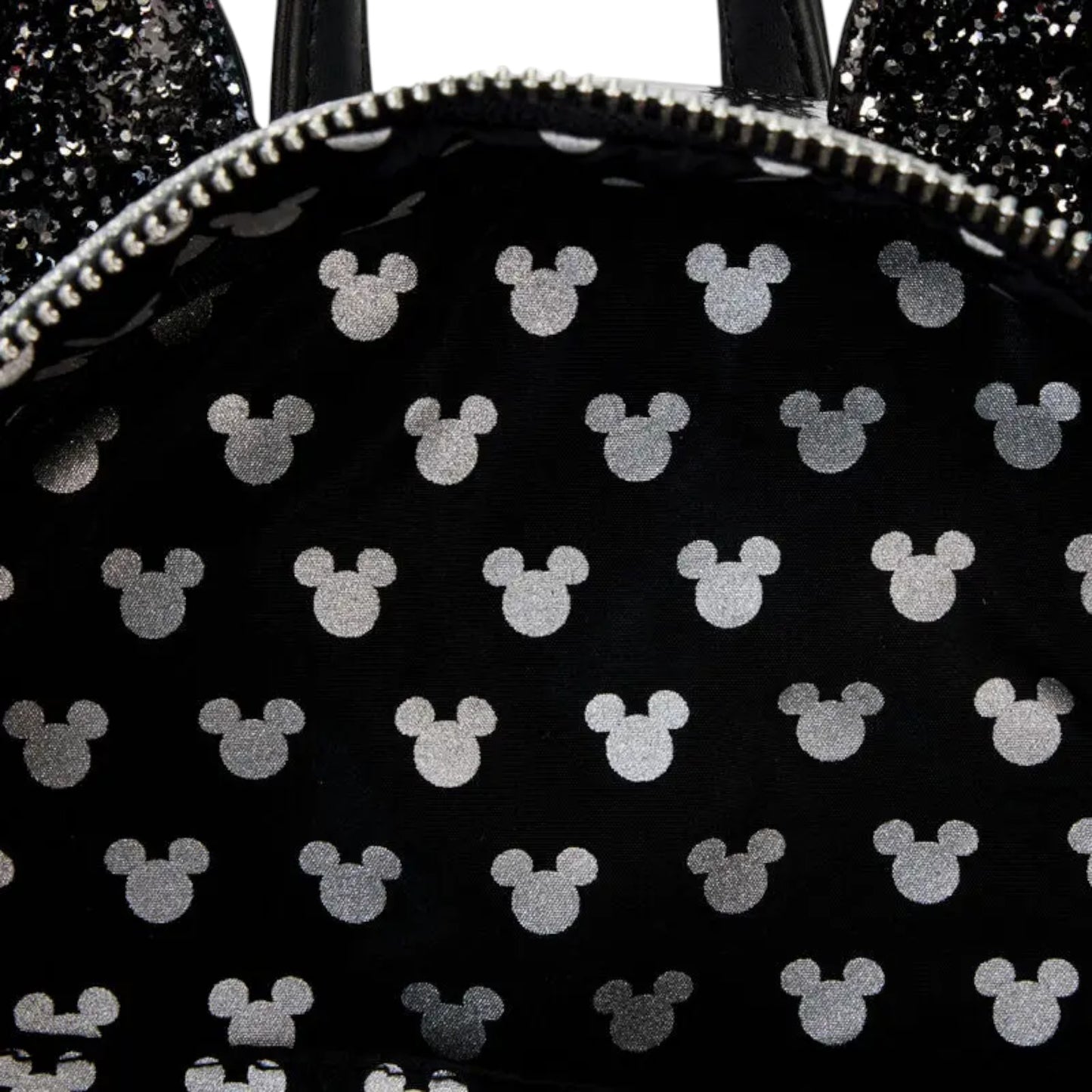 Inside Black backpack with white Mickey Mouse icons on a black background
