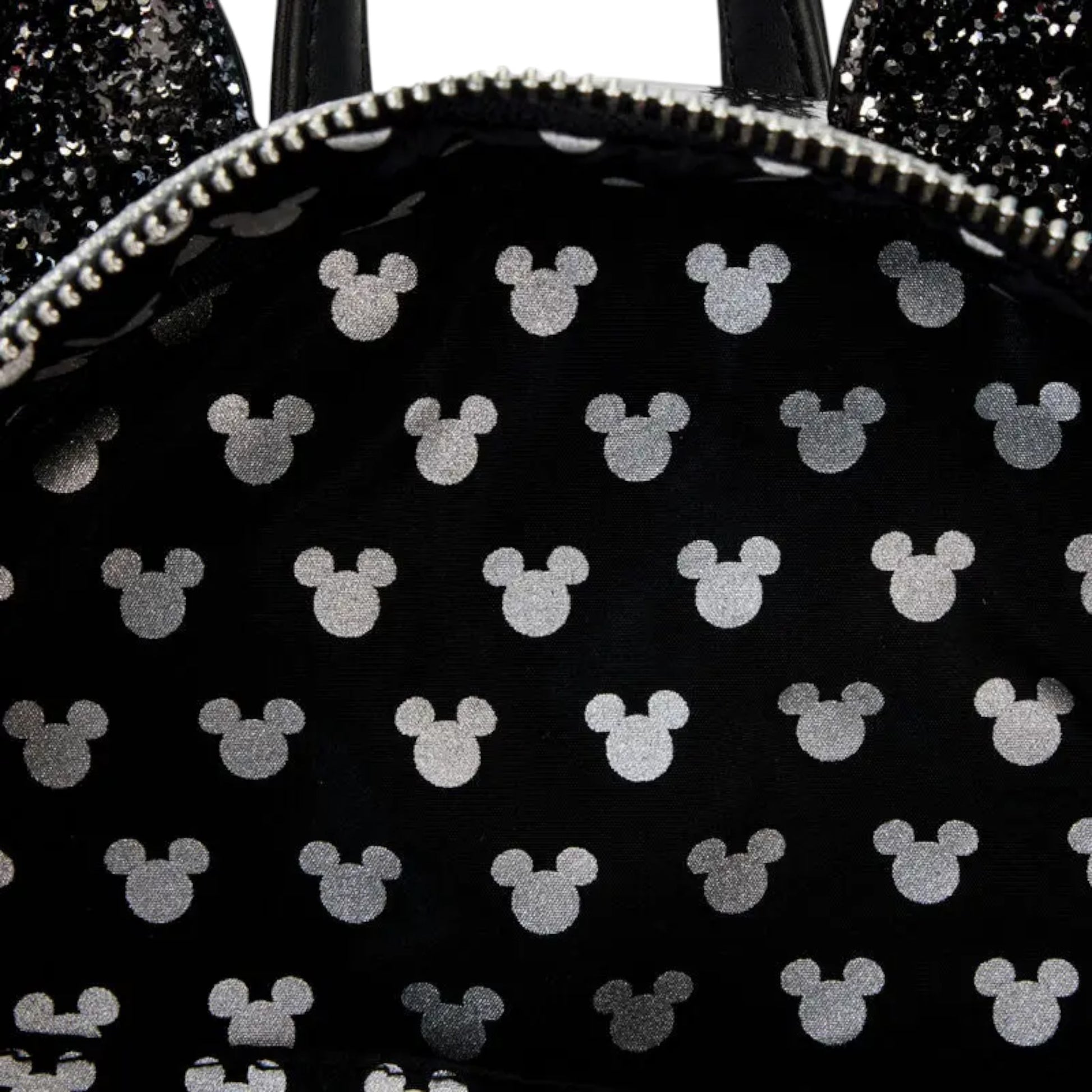 Inside Black backpack with white Mickey Mouse icons on a black background