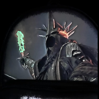 Nazgul glowing with a fiery sword with a green light effect on a dark background