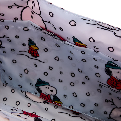 Close-up of inside of bag with fabric with Snoopy and Woodstock pattern on a white background