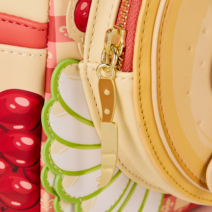 Side view close-up of the  with a mini backpack showing a knife charm and cherry design.