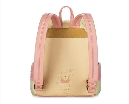 Pink and gold backpack with Winnie the Pooh on a white background